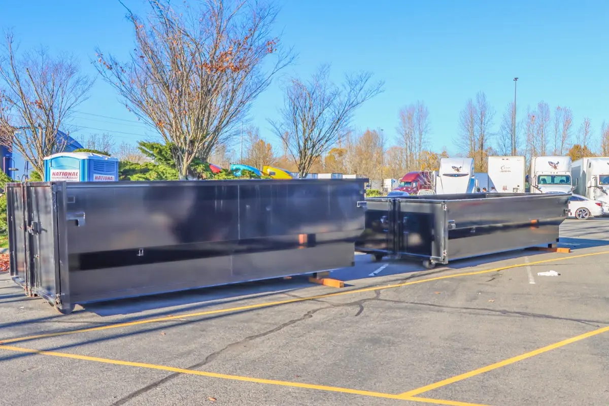 Professional dumpster rental service with roll-off container on residential driveway in Toledo